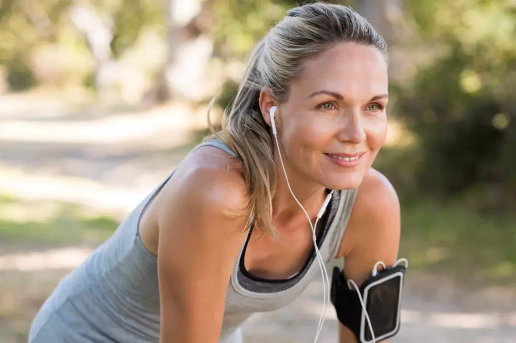 A woman pausing during outdoor exercise