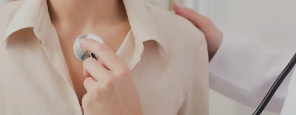 A stethoscope held against a patient’s chest